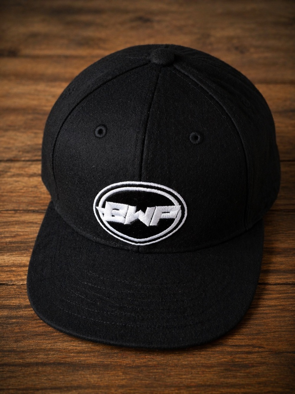 The Classic Felt Black Snapback Hat with White Embroidered Logo